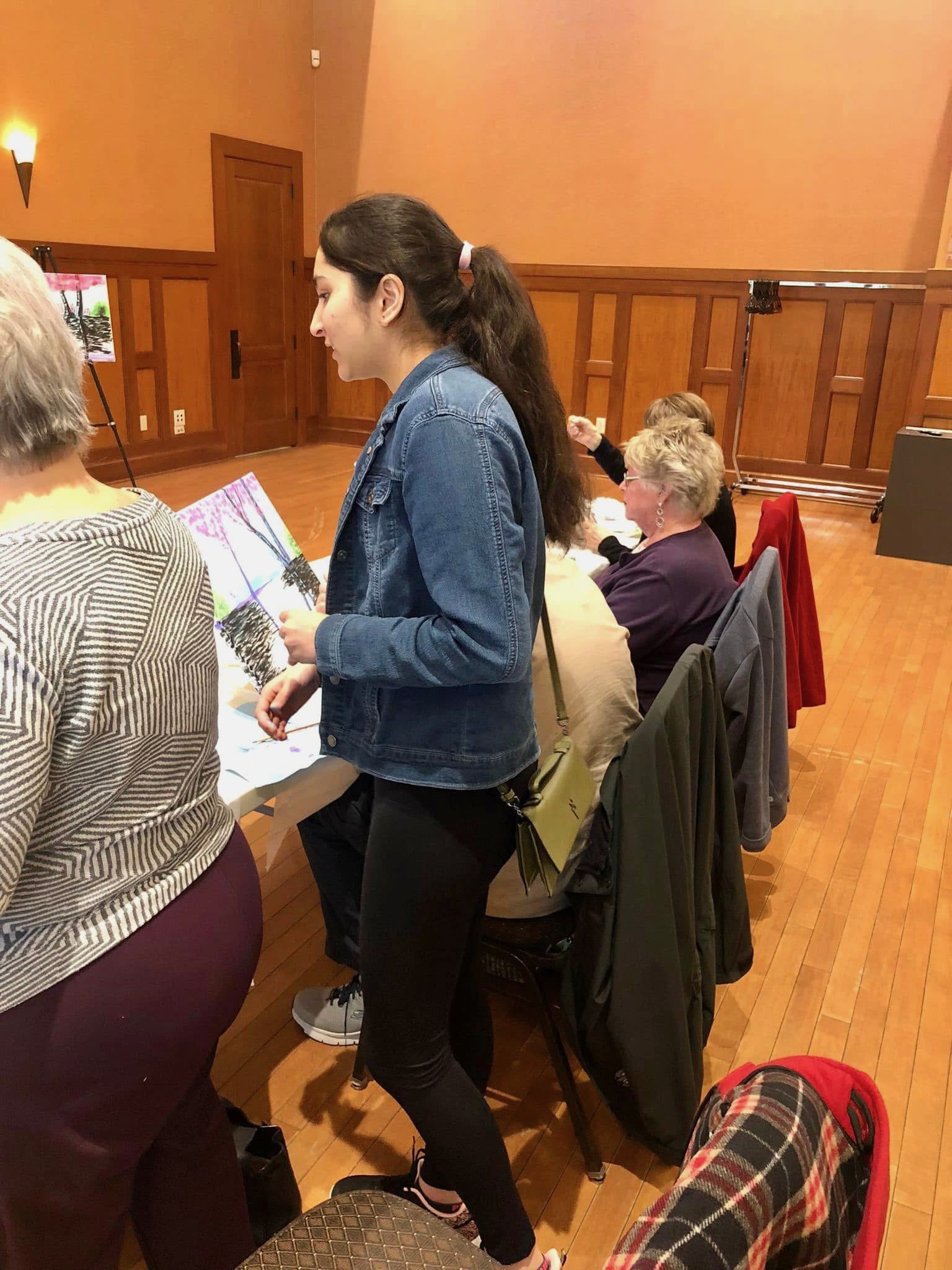 Teaching painting workshop at assisted living facility